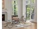 Cozy living space with fireplace and view of outdoor balcony through glass paneled doors at 725 Riley Pl, Atlanta, GA 30327