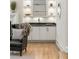 Living room featuring a wet bar with white cabinets, a black countertop, and illuminated shelving at 725 Riley Pl, Atlanta, GA 30327