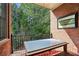 Cozy balcony with glass table and outdoor rug is perfect for relaxing and enjoying the view at 1276 Edmund Ne Ln, Brookhaven, GA 30319