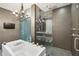 Bathroom featuring a modern tub with a chandelier and glass-enclosed shower at 1276 Edmund Ne Ln, Brookhaven, GA 30319