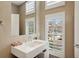 Modern bathroom with stylish white sink and fixtures, tile walls and shuttered windows with a view at 1276 Edmund Ne Ln, Brookhaven, GA 30319