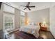 Bright bedroom with a ceiling fan, shuttered windows, a comfy rug, and neutral decor at 1276 Edmund Ne Ln, Brookhaven, GA 30319
