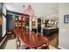 Open-concept dining room featuring a large wood table and stylish red pendant lighting at 1276 Edmund Ne Ln, Brookhaven, GA 30319