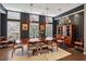 Elegant dining room with dark walls, a large table, and striking light fixtures at 1276 Edmund Ne Ln, Brookhaven, GA 30319