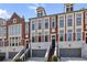 Elegant brick townhomes feature stone accents, multi-pane windows, and attached garages at 1276 Edmund Ne Ln, Brookhaven, GA 30319
