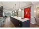 Bright, open kitchen featuring a central island with bar seating and a red barn door accent at 1276 Edmund Ne Ln, Brookhaven, GA 30319