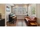 Cozy living room features a bar, a leather sofa and three large windows allowing ample natural light at 1276 Edmund Ne Ln, Brookhaven, GA 30319