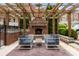 Cozy brick patio with an outdoor fireplace and comfortable seating area under a wooden pergola at 1276 Edmund Ne Ln, Brookhaven, GA 30319