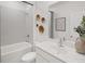 Modern bathroom featuring a bathtub, sleek vanity with a large mirror, tiled walls, and decorative gold accents at 1407 Bluffs Ridge Way, Canton, GA 30114