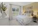 Inviting bedroom with a large window, plush carpet, stylish decor, and a comfortable queen-sized bed at 1407 Bluffs Ridge Way, Canton, GA 30114