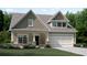 Charming two-story home showcasing a classic design, a two-car garage, and a beautifully landscaped front yard at 1407 Bluffs Ridge Way, Canton, GA 30114
