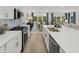 Modern kitchen with white cabinets, granite countertops, stainless steel appliances, and beautiful wood flooring at 1407 Bluffs Ridge Way, Canton, GA 30114