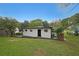The back exterior features light siding, black trim and a large grassy area at 2610 Knoll Se Rd, Smyrna, GA 30080