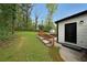 Lovely backyard featuring a spacious lawn, wooden steps and access to the home's exterior at 2610 Knoll Se Rd, Smyrna, GA 30080