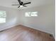 Bright bedroom features hardwood floors, modern ceiling fan, and natural light from windows at 2610 Knoll Se Rd, Smyrna, GA 30080
