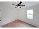 A bright bedroom with wood-look floors has a modern ceiling fan and a window at 2610 Knoll Se Rd, Smyrna, GA 30080