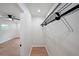 Walk-in closet with laminate floors, wire shelving and storage racks with a bedroom beyond at 2610 Knoll Se Rd, Smyrna, GA 30080