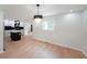 Bright dining area next to kitchen with wood floors, modern chandelier at 2610 Knoll Se Rd, Smyrna, GA 30080