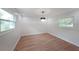 Bright dining room with wood floors, modern chandelier, and two large windows at 2610 Knoll Se Rd, Smyrna, GA 30080