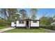 Charming renovated home with a modern black and white exterior and landscaped front yard at 2610 Knoll Se Rd, Smyrna, GA 30080