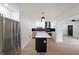 Spacious open-concept kitchen featuring stainless steel appliances, a black island, and modern lighting at 2610 Knoll Se Rd, Smyrna, GA 30080