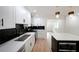 Modern kitchen with black backsplash, white cabinets, quartz countertops, and stainless steel appliances at 2610 Knoll Se Rd, Smyrna, GA 30080