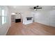 Bright open-concept living room featuring wood floors, electric fireplace, and ceiling fan at 2610 Knoll Se Rd, Smyrna, GA 30080