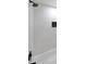 Close-up of white subway tile shower with rain shower head, black hardware, and inset tiled niche at 2610 Knoll Se Rd, Smyrna, GA 30080