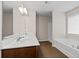 Bathroom with double vanity, white countertops, wooden cabinets, and soaking tub at 275 Denver Ave, Hiram, GA 30141
