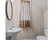 Powder room features a pedestal sink, oval mirror, and window with neutral-colored curtains at 275 Denver Ave, Hiram, GA 30141
