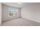 Bright bedroom with a large window, plush carpet and neutral walls at 275 Denver Ave, Hiram, GA 30141