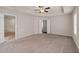 Large primary bedroom featuring plush carpet, a tray ceiling, and a ceiling fan at 275 Denver Ave, Hiram, GA 30141