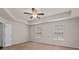 Spacious Primary bedroom featuring tray ceilings, carpet flooring, and a ceiling fan at 275 Denver Ave, Hiram, GA 30141