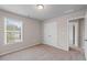 Bright, carpeted bedroom with natural light and a double door closet for ample storage at 275 Denver Ave, Hiram, GA 30141