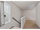 Upstairs hallway with carpeted floors, window, and wooden railing at 275 Denver Ave, Hiram, GA 30141