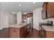 Well-lit kitchen features a central island, modern appliances, dark cabinets, and open floor plan at 275 Denver Ave, Hiram, GA 30141