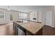 Kitchen island with granite countertops, stainless steel appliances, open to the Gathering room with fireplace at 275 Denver Ave, Hiram, GA 30141