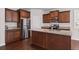 Spacious kitchen with dark cabinets, granite countertops, stainless steel appliances, and wood floors at 275 Denver Ave, Hiram, GA 30141