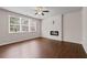 Spacious living room showcasing gleaming hardwood floors, fireplace, and a ceiling fan at 275 Denver Ave, Hiram, GA 30141