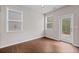 Bright living room with hardwood floors, windows, and glass door to the backyard at 275 Denver Ave, Hiram, GA 30141