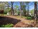 Lush backyard with small deck, sheds, and surrounding trees at 3742 Linecrest Rd, Ellenwood, GA 30294