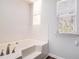 Large white bathtub with jets and tile surround next to a window with blinds at 3742 Linecrest Rd, Ellenwood, GA 30294