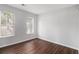 Bright bedroom featuring wood floors and two windows bringing in ample natural light at 3742 Linecrest Rd, Ellenwood, GA 30294