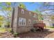 A view of the back exterior of the home and the raised deck and small yard at 3742 Linecrest Rd, Ellenwood, GA 30294