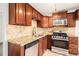 Well-equipped kitchen with modern appliances, tile floors, sleek granite countertops, and stylish cabinetry at 3742 Linecrest Rd, Ellenwood, GA 30294