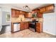 Kitchen featuring sleek granite countertops, modern stainless steel appliances, and tiled flooring at 3742 Linecrest Rd, Ellenwood, GA 30294