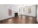 Bright living room with hardwood floors, a cozy fireplace, and large windows offering ample natural light at 3742 Linecrest Rd, Ellenwood, GA 30294