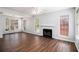 Bright living room with hardwood floors, a cozy fireplace, and large windows offering ample natural light at 3742 Linecrest Rd, Ellenwood, GA 30294
