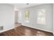 Bright living room with wood floors and a pair of windows with wooden blinds at 3742 Linecrest Rd, Ellenwood, GA 30294