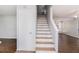Bright staircase showcasing white risers and natural wood steps between floors at 3742 Linecrest Rd, Ellenwood, GA 30294